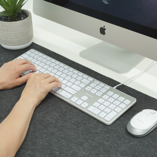 Macally wired keyboard and mouse combo for Mac in Silver - typing at an iMac desk setup