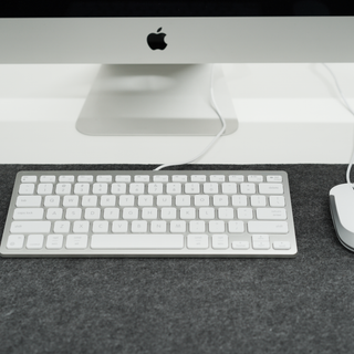 Macally compact keyboard and mouse combo in silver - lifestyle on desk with iMac