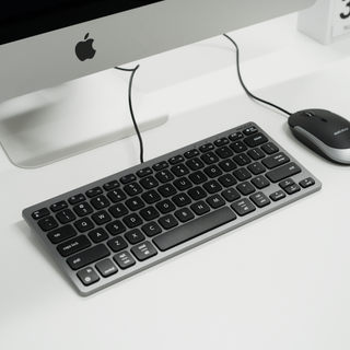 Macally Compact Keyboard and Mouse Combo in Space Gray - on a desk with an iMac