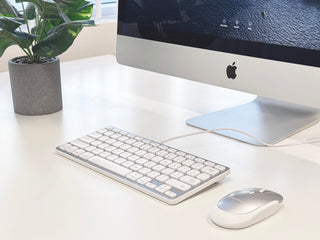 Macally compact wired keyboard and mouse on clean white desk with iMac showing modern Mac workspace setup